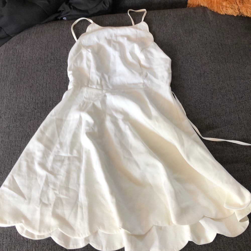 white dress with ruffle at the bottom